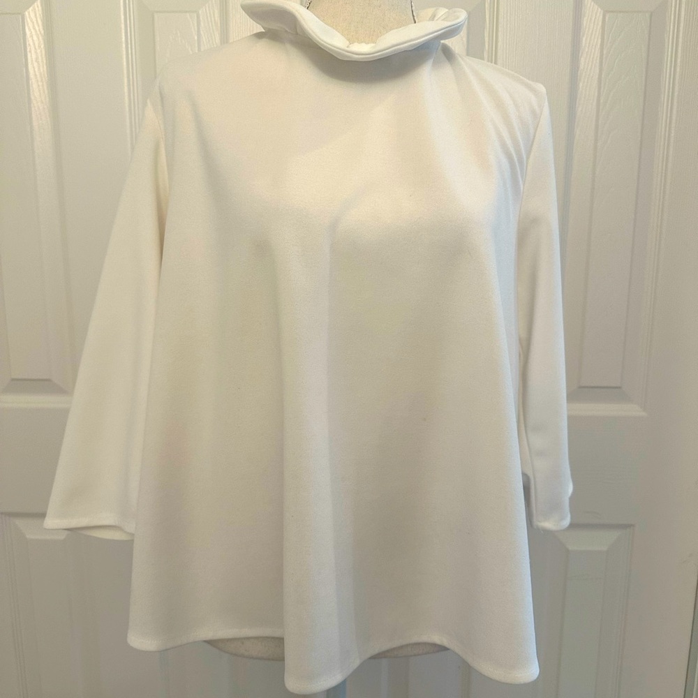 Pomander Place white ruffle neckline top with bow in the back. Well loved.